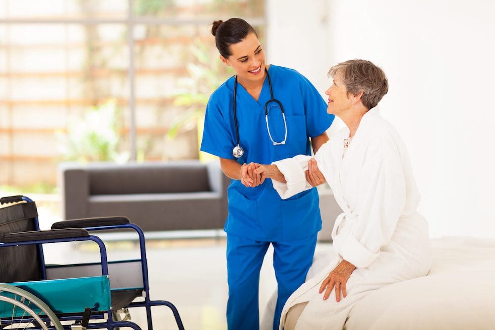 A nurse is talking to an elderly patient.